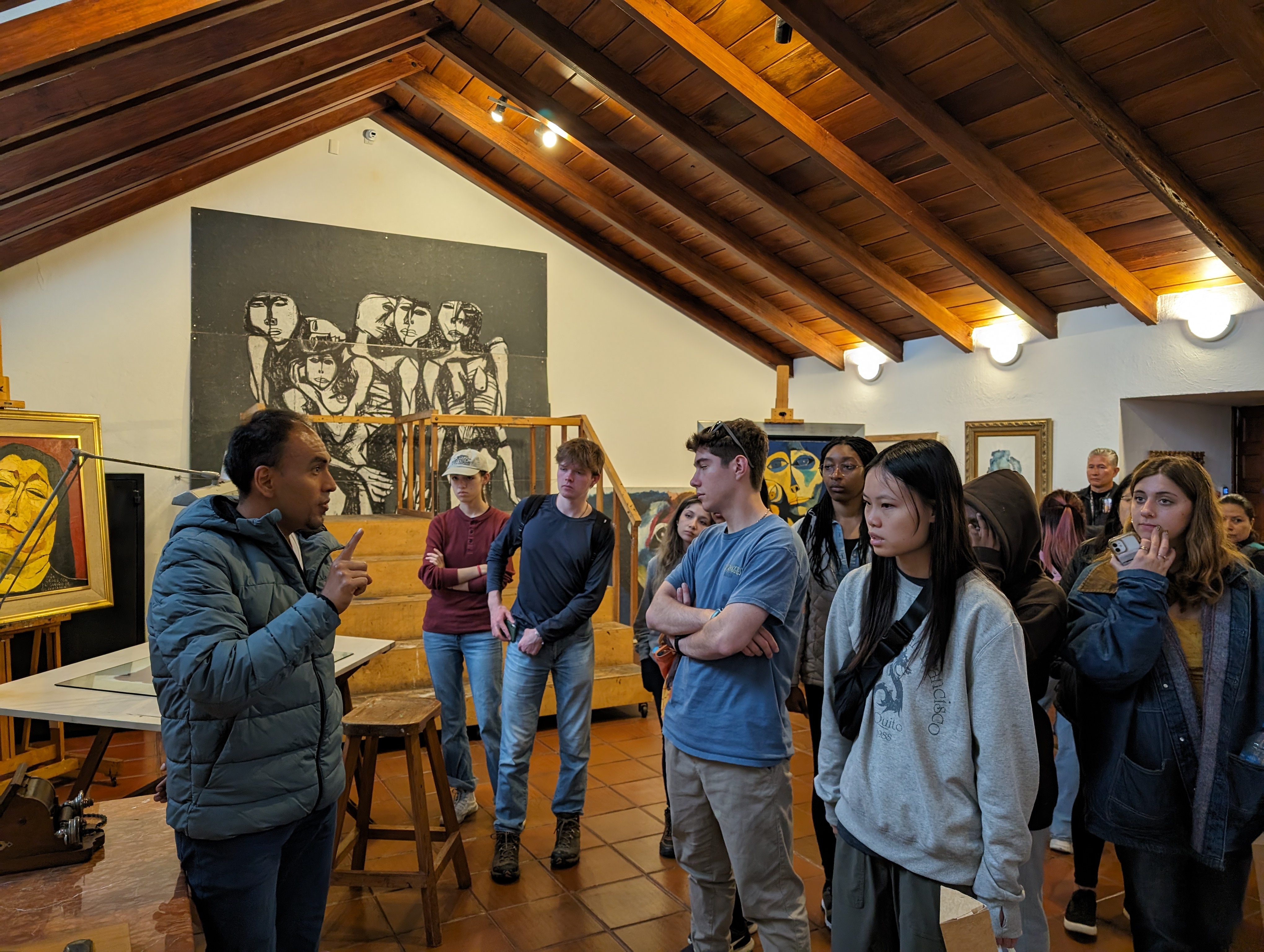 Students listening to speaker in Ecuador museum